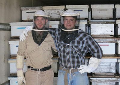 two beekeepers in transport truck